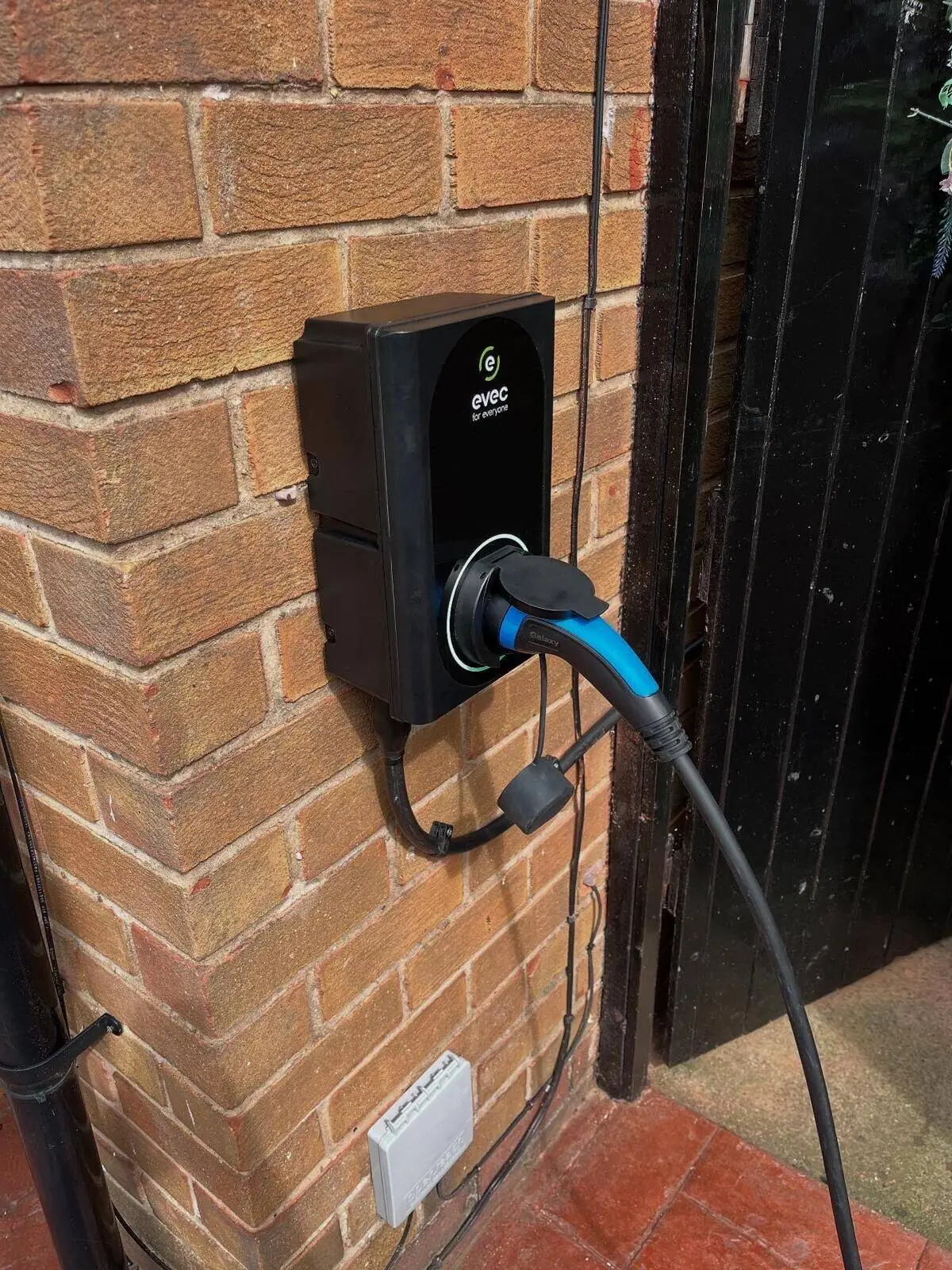 EVEC 7.4kW EV charger installed on an outdoor wall in Maghull